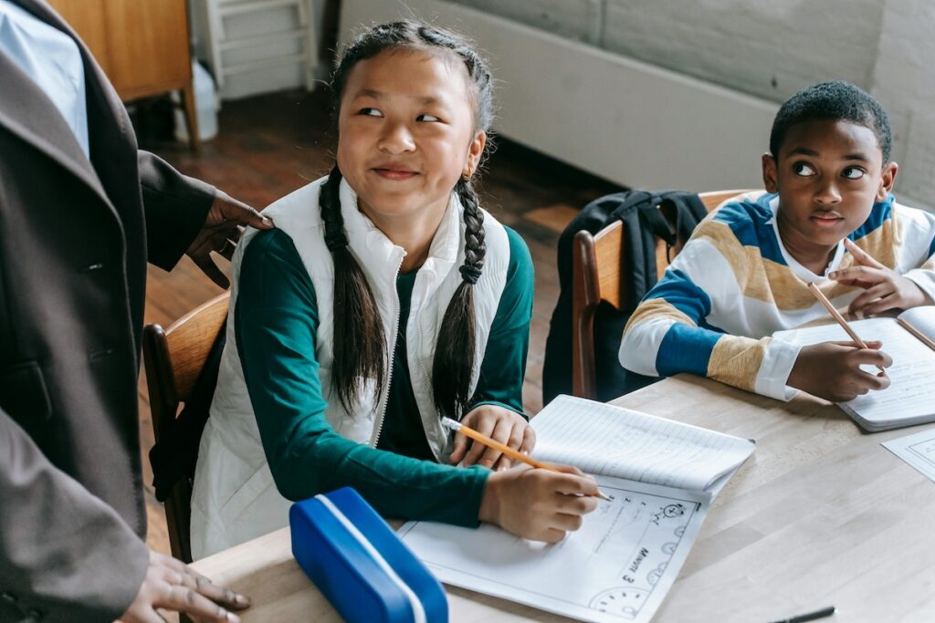 Photo by Katerina Holmes: https://www.pexels.com/photo/smart-diverse-kids-with-teacher-in-classroom-5905920/